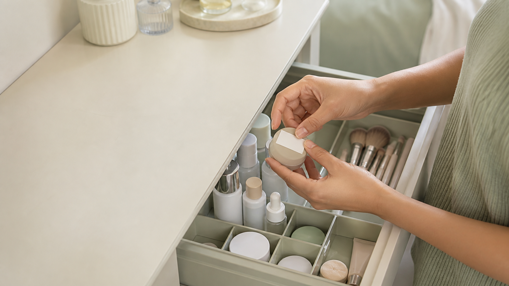 Hands organizing unbranded cosmetics in a clean drawer and marking an opening date